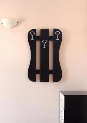 a black guitar magnet hanging on a wall at Horizont Apartments in Sunny Beach