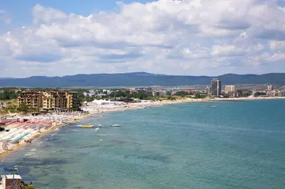 a beach with lots of umbrellas and people on it at Sea View Apartment In PARADISO in Nesebar