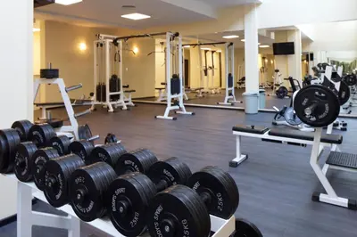 a gym with rows of dumbbells and other equipment at Sea View Apartment In PARADISO in Nesebar