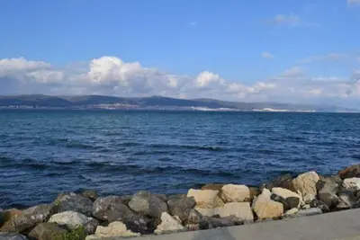 a large body of water with rocks on the shore at Sea View Apartment In PARADISO in Nesebar