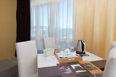 a dining room with a table and chairs and a window at Sea View Apartment In PARADISO in Nesebar