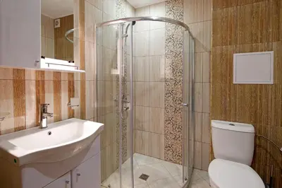 a bathroom with a shower and a toilet and a sink at Sea View Apartment In PARADISO in Nesebar