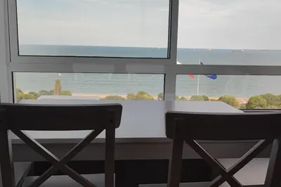 a table and two chairs in front of a window at SEA VIEW FLORA in Burgas City
