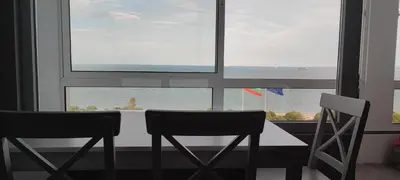 a table and two chairs in front of a window at SEA VIEW FLORA in Burgas City