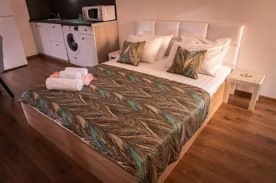 a bedroom with a bed with a stuffed animal on it at bellissimo студио близо до плажа in Ravda