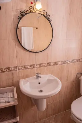 a bathroom with a sink and a mirror at bellissimo студио близо до плажа in Ravda