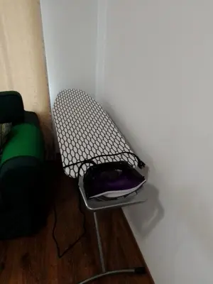 a chair sitting in a corner of a room at bellissimo студио близо до плажа in Ravda