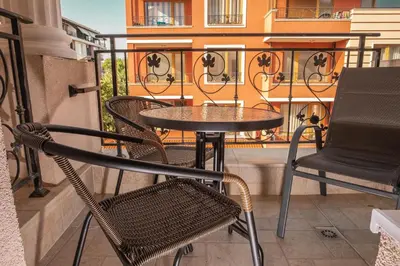 a small table and chairs on a balcony at bellissimo студио близо до плажа in Ravda