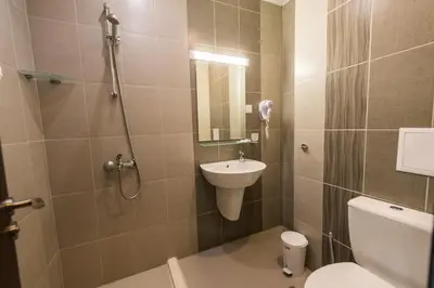 a bathroom with a shower and a toilet and a sink at Polina Beach in Sozopol
