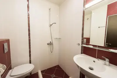 a bathroom with a toilet and a sink and a shower at Polina Beach in Sozopol
