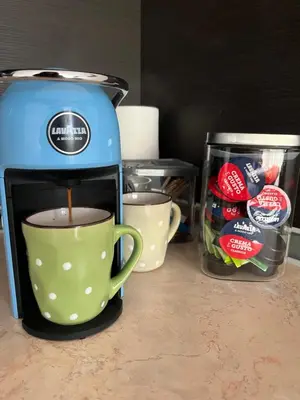 a coffee maker and a cup of coffee on a counter at Лятно студио in Sveti Vlas