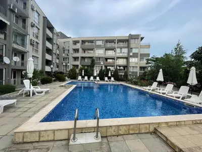 a swimming pool in front of a apartment building at Лятно студио in Sveti Vlas