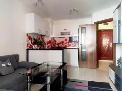 a living room with a couch and a glass table at Modern apartment in Burgas in Burgas City