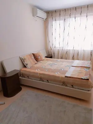 a small bedroom with a bed with a window at Modern apartment in Burgas in Burgas City