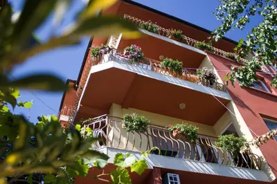 a building with potted plants on the balconies at Violeta 7 Guest House in Nesebar