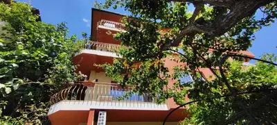 a red and white building with a balcony at Violeta 7 Guest House in Nesebar