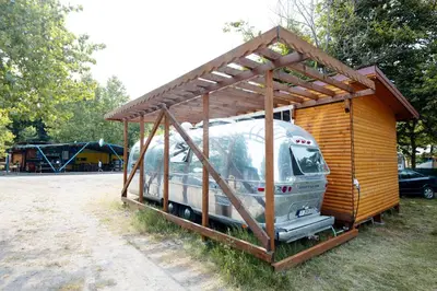 a large recreational vehicle parked in a shed at Luxury Vintage Airstream RV/Caravan Retro Charm Meets Comfort in Kiten