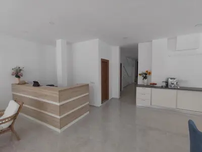 a kitchen with white walls and a wooden counter at ARIA in Primorsko