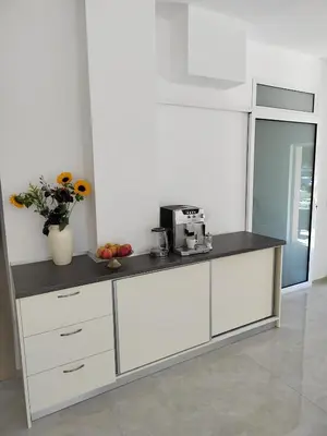 a kitchen with white cabinets and a counter top at ARIA in Primorsko