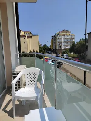 a white chair sitting on top of a balcony at ARIA in Primorsko