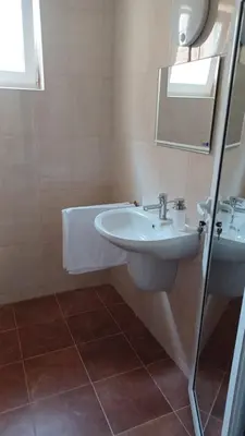 a bathroom with a white sink and a mirror at ARIA in Primorsko