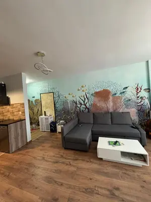 a living room with a couch and a painting on the wall at Desis Seaside Hideaway in Pomorie