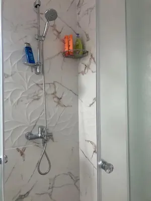 a shower in a bathroom with a glass door at Desis Seaside Hideaway in Pomorie