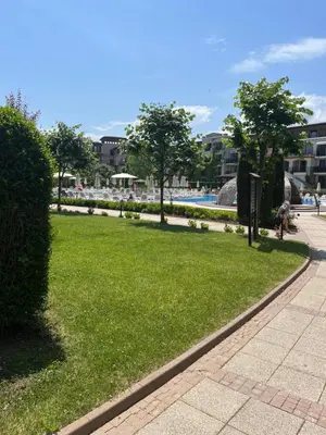 a park with green grass and trees next to a pool at Green Life Private SP apartments -Sozopol in Sozopol