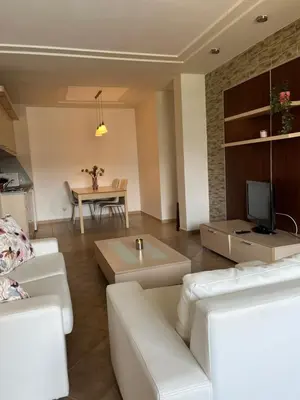 a living room with white furniture and a table at Green Life Private SP apartments -Sozopol in Sozopol