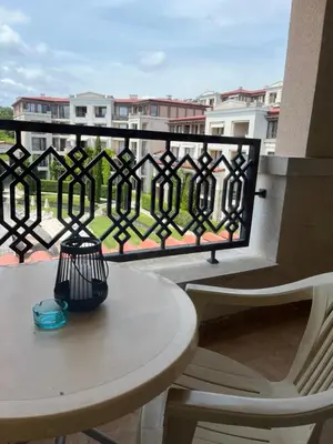 a white table and chairs on a balcony with a view at Green Life Private SP apartments -Sozopol in Sozopol