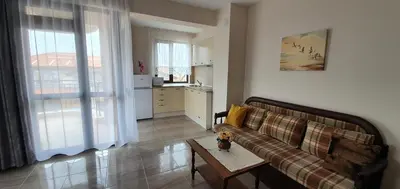 a living room with a couch and a table at Luxury Apartments Ekaterina in Chernomorets