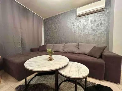 a living room with a couch and a table at By The Sea Apartment in Varna City