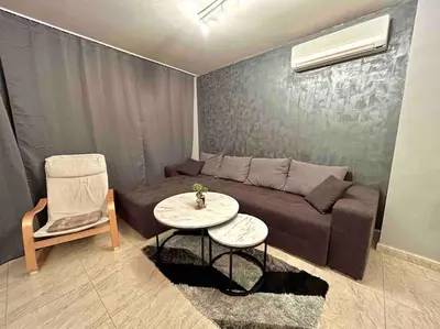 a living room with a couch and a table at By The Sea Apartment in Varna City