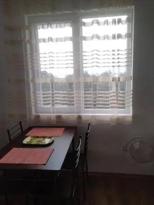 a dining room with a table and a window at Апартаменты за гости Гаван in Byala