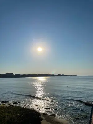 a view of the ocean with the sun in the sky at Ив-Бо in Ravda