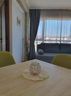 a table with a bowl on top of it in a living room at Vromos Guest House in Chernomorets