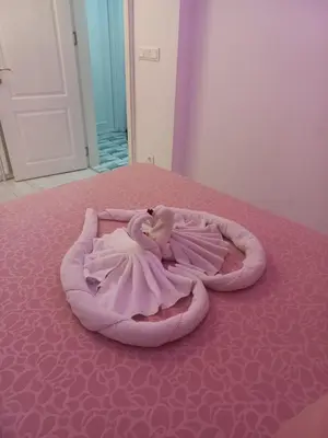 a pink blanket on top of a bed at Apartment Krisiya in Burgas in Burgas City