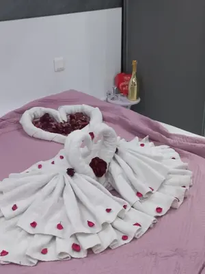 a bed with two swans made out of towels at Apartment Krisiya in Burgas in Burgas City