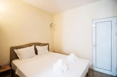 a bedroom with two beds with towels on them at Central location and FREE parking in Varna City