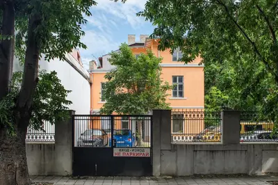 a fence in front of a building with a house at Central location and FREE parking in Varna City