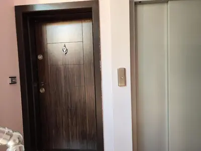 a brown door with a sign on it in a room at апартамент Зевс in Pomorie