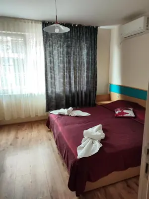 a bedroom with two beds with towels on them at апартамент Зевс in Pomorie