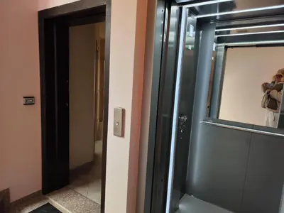 a person taking a picture of a mirror in a bathroom at апартамент Зевс in Pomorie