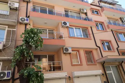 a building with balconies on the side of it at апартамент Зевс in Pomorie