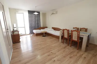 a living room with a table and a couch at апартамент Зевс in Pomorie