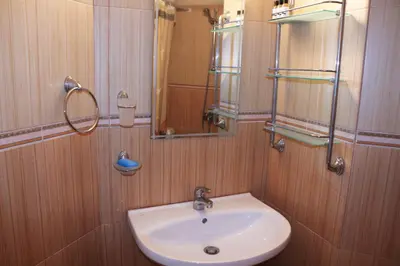 a bathroom with a sink and a mirror at Kapriz Apartment in Kiten