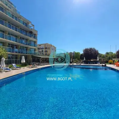 a large swimming pool in front of a building at Sunny Holiday - Cacao Beach Apartments in Sunny Beach