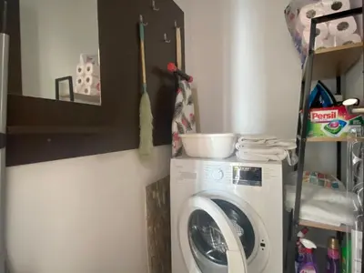 a laundry room with a washing machine and a shelf at PARADISO 'В' 207 Two Bedroom Apartment in Nesebar