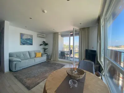 a living room with a couch and a table at PARADISO 'В' 207 Two Bedroom Apartment in Nesebar