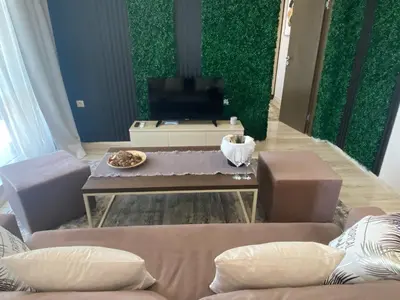 a living room with a couch and a table and a tv at PARADISO 'В' 607 Large Luxury Apartment in Nesebar